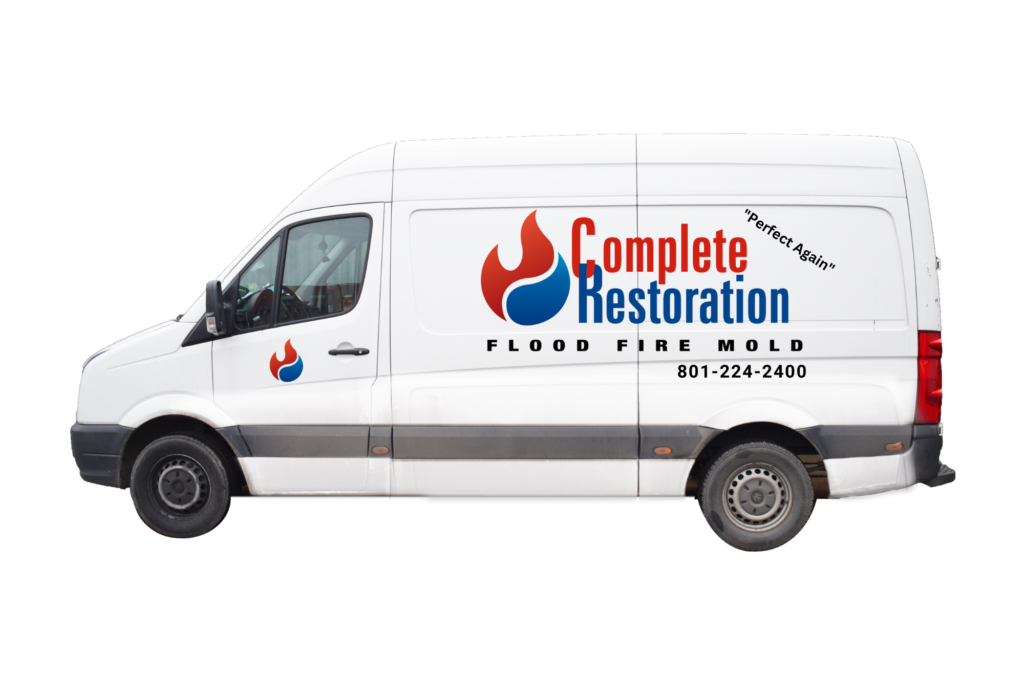 Service truck with the Complete Restoration logo and contact information, providing 24/7 water and fire damage restoration services in Utah County, Salt Lake County, and Wasatch County.