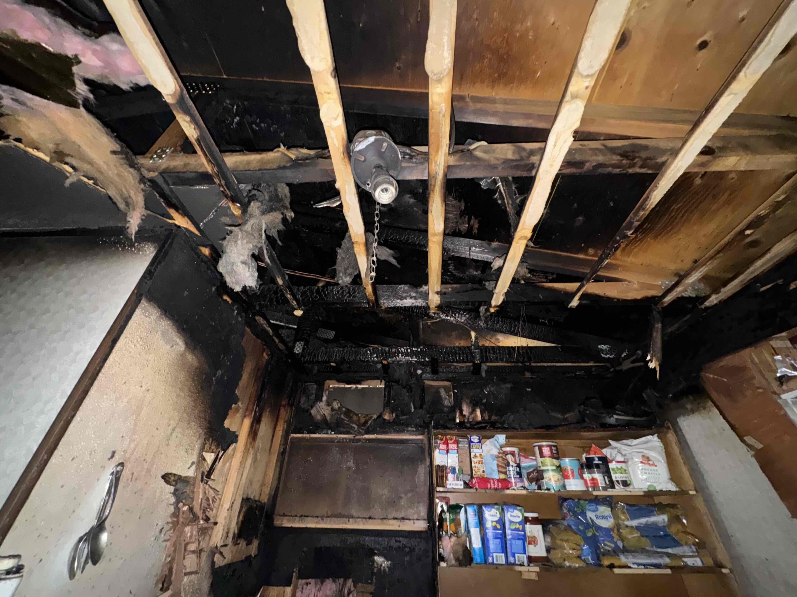 Fire in a kitchen causes smoke and fire damage.